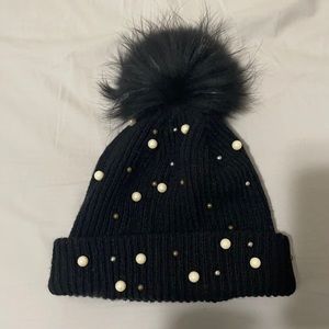 Black pompom hat with pearl and bead appliqués